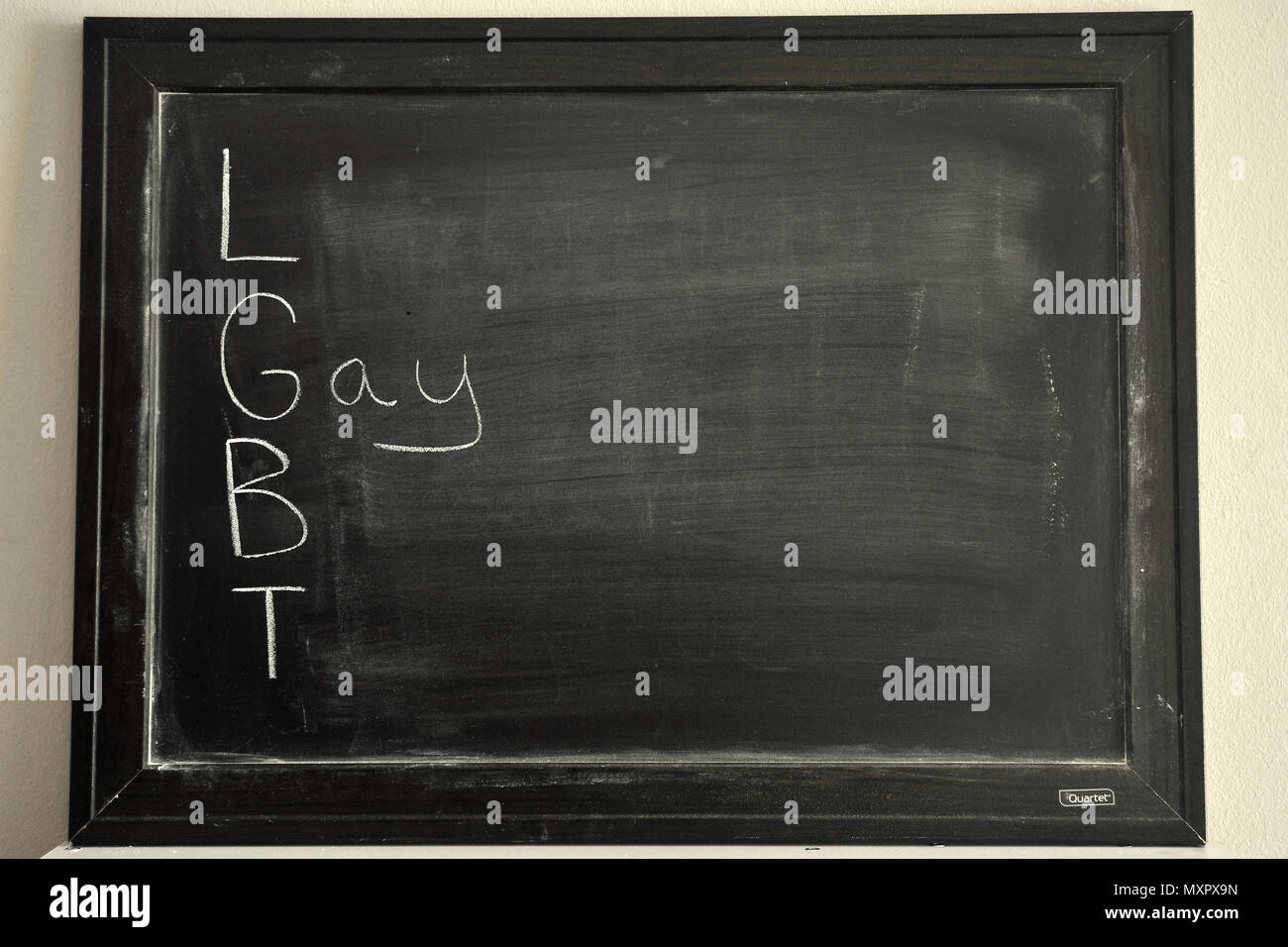 xxxxx written in white chalk on a blackboard. Stock Photo