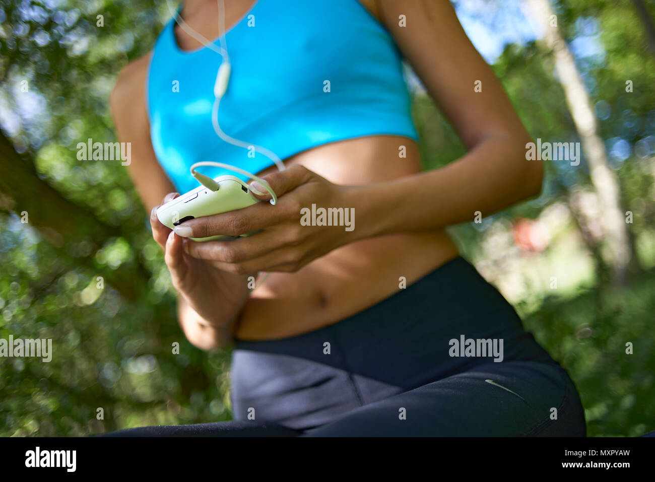 Close Up Of An Athletic Woman Wearing Sports Clothing Sitting On A