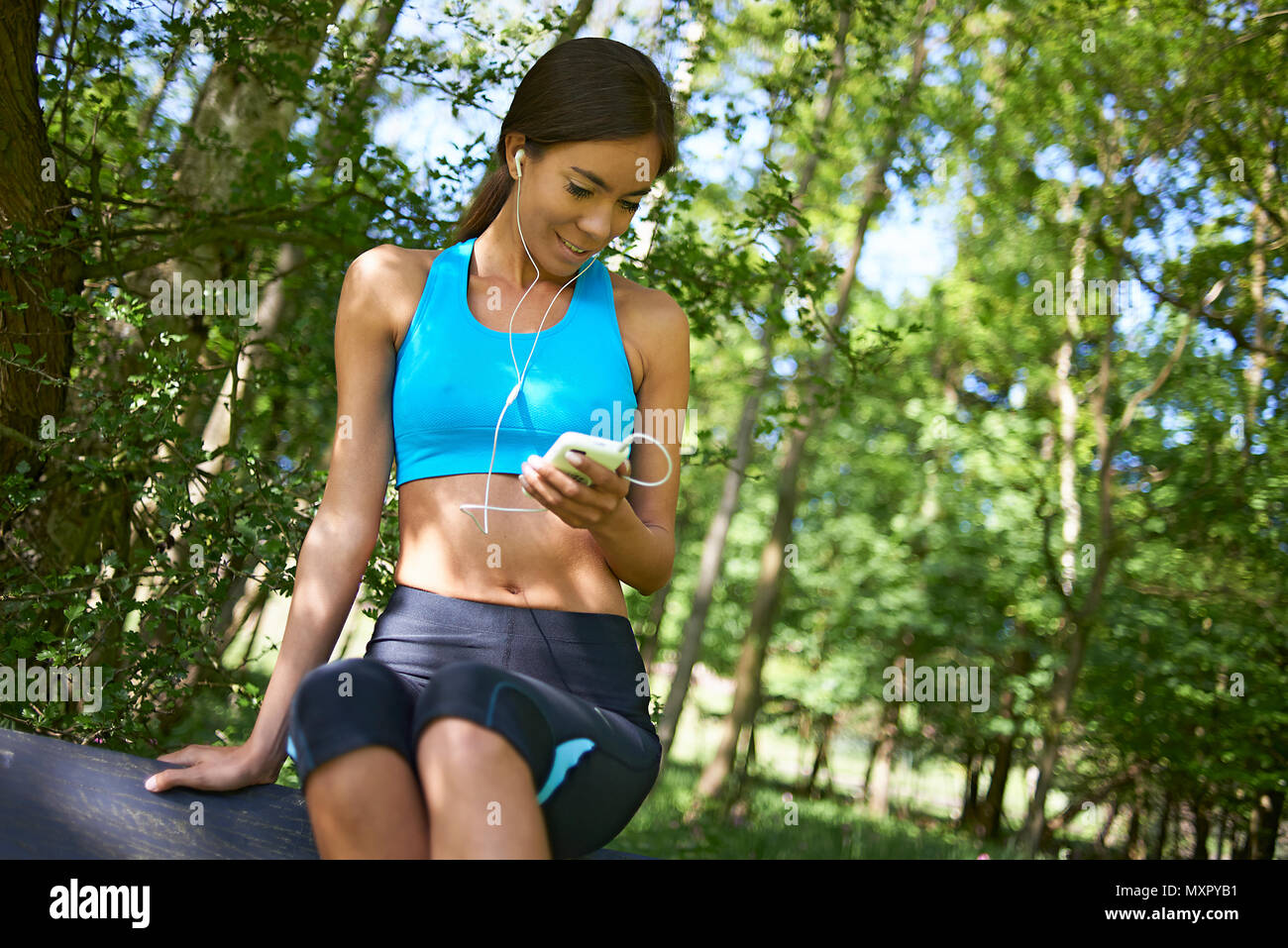 Close Up Of An Athletic Woman Wearing Sports Clothing Sitting On A