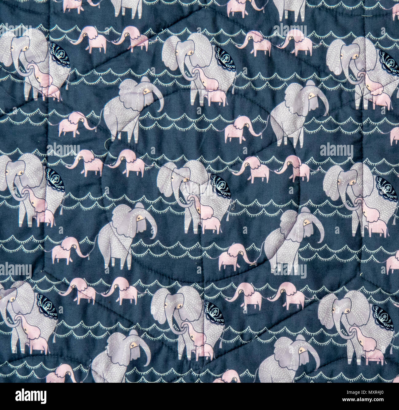 A quilt with pictures of pink and grey elephants Stock Photo Alamy