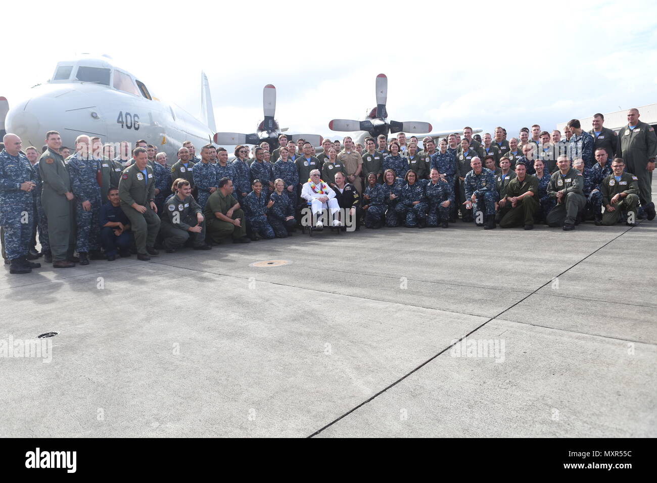 Melvin Heckman, a Pearl Harbor survivor, poses for a photo with the sailors of Patrol Squadron 9 next to a P-3C Orion aboard Marine Corps Base Hawaii, December 2, 2016. Heckman is known for rescuing sailors from the USS Arizona during the attack on Pearl Harbor after the ship was attacked by Japanese Zeros. 'I reached out to grab a man's hand to help him up and take him to the island,' said Heckman, a Sheridan, Wyoming, native. 'I got him out of the water and saw that everything below his belly button was missing; he died in my arms'  Heckman was awarded a purple heart for his bravery after re Stock Photo