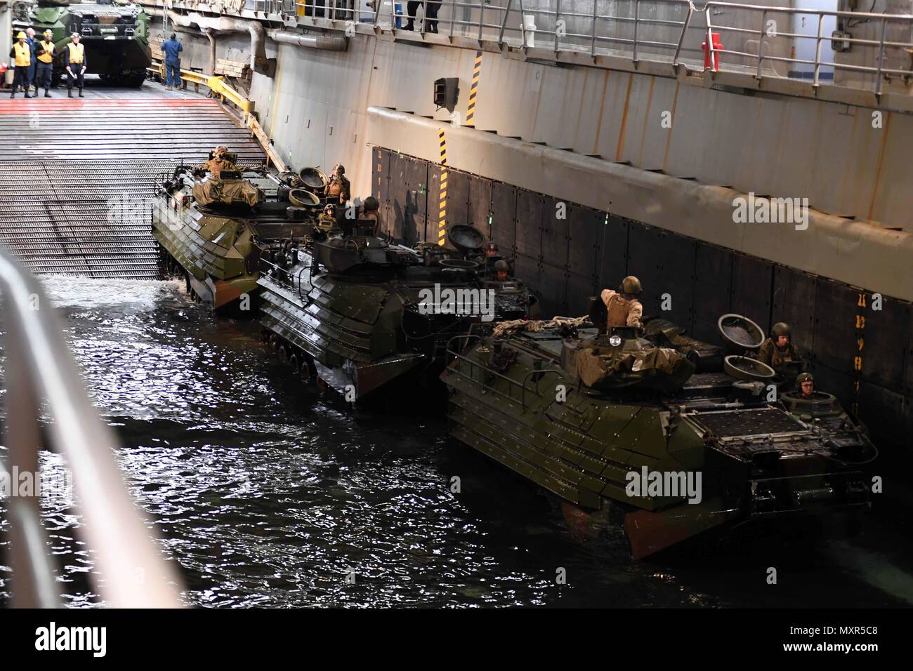 161202-N-ME988-278 ATLANTIC OCEAN (Dec. 02, 2016) Amphibious assault vehicles (AAV) with the 24th Marine Expeditionary Unit (MEU) return to the well deck onboard the amphibious dock landing ship USS Carter Hall (LSD 50). The ship is underway with the Bataan Amphibious Readiness Group (ARG) participating in ARG/Marine Expeditionary Unit Exercise (ARG/MEUEX). (U.S. Navy photo by Petty Officer 1st Class Darren M. Moore/Released) Stock Photo