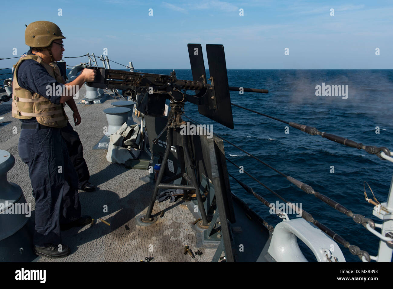161121-N-EO381-248  ARABIAN GULF (Nov. 21, 2016) Petty Officer 3rd Class Alexander Lee, assigned to the guided-missile destroyer USS Nitze (DDG 94), fires a .50-caliber machine gun during a live fire exercise. Lee serves onboard Nitze as an electronics technician and is responsible for maintaining, repairing and calibrating shipboard electronic equipment. Nitze, deployed as part of the Eisenhower Carrier Strike Group, is supporting maritime security operations and theater security cooperation efforts in the U.S. 5th Fleet area of operations. (U.S. Navy photo by Petty Officer 3rd Class Casey J. Stock Photo
