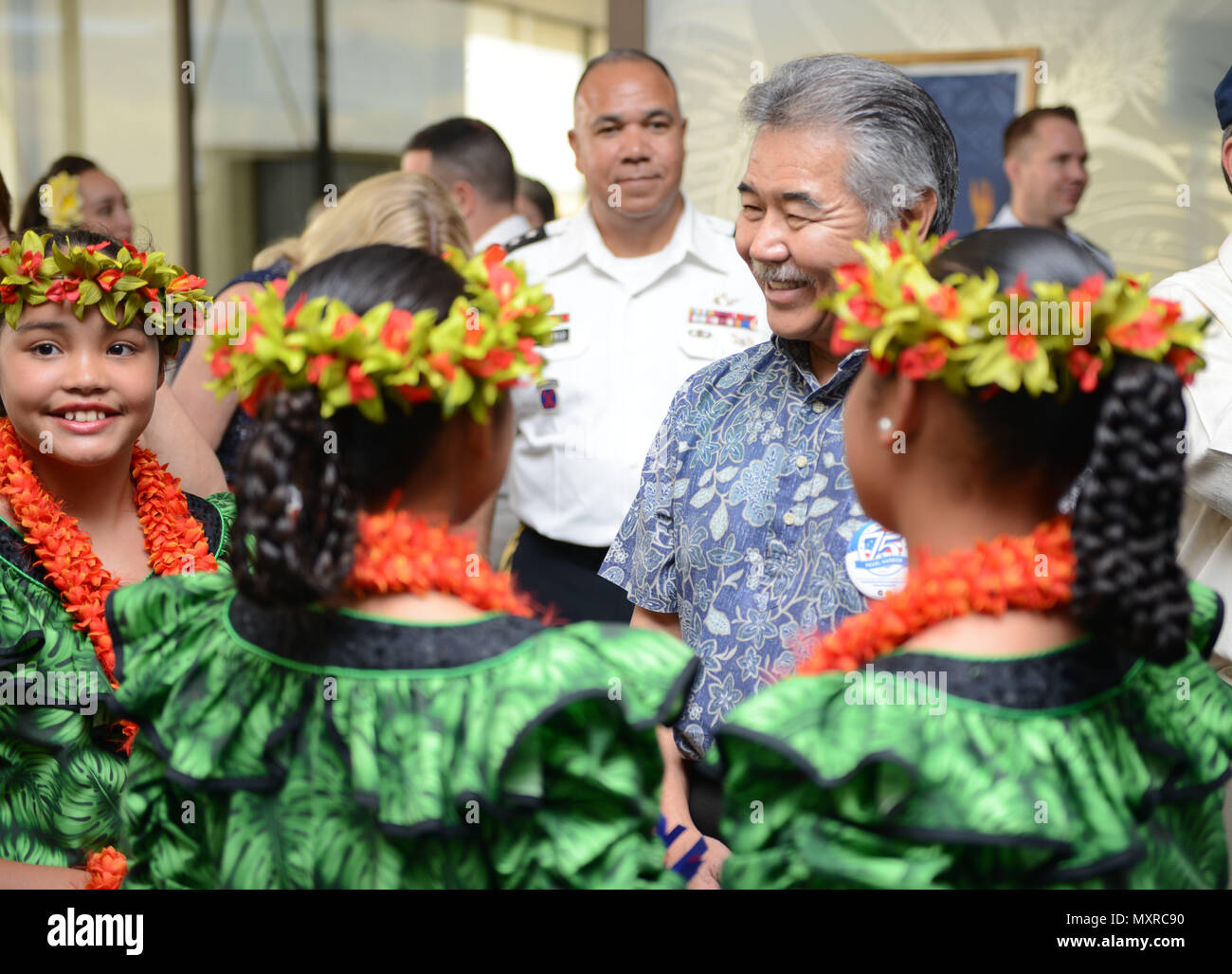 hawaii state governor david y ige speaks with several young girls