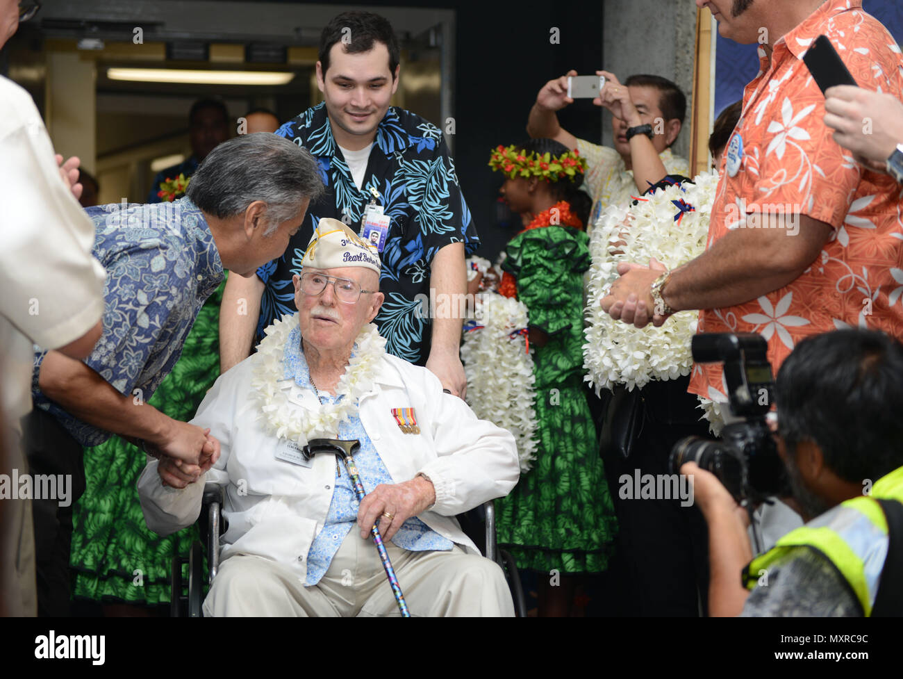hawaii state governor david y ige shakes the hand of a pearl