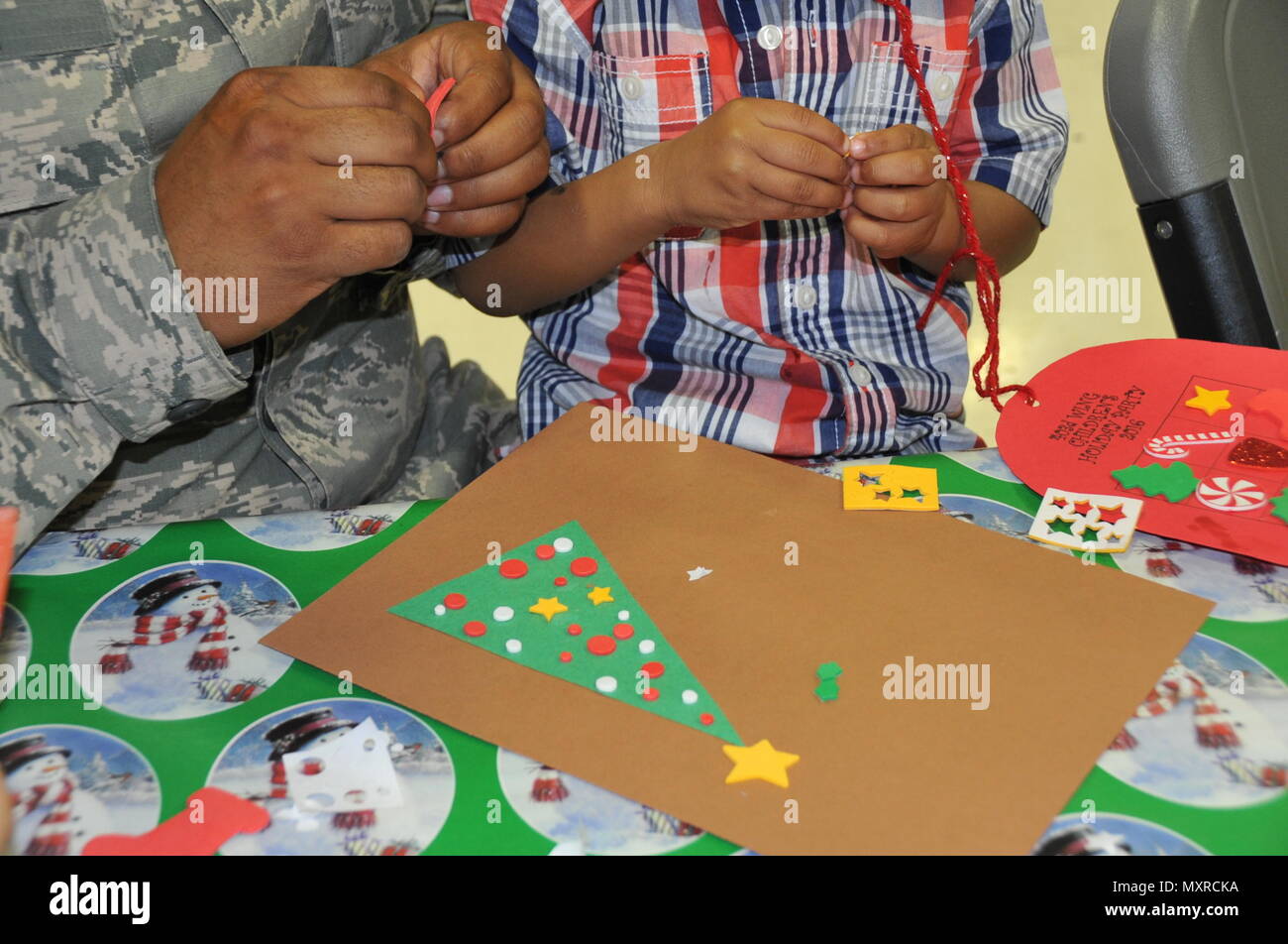 Staff Sgt William Pierce 403rd Maintenace Squadron fuel cell specialist and his son Mason work to her to create a Christmas card Members of the 403rd