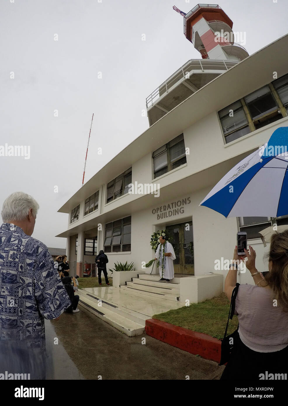 161204-N-GI544-308 PEARL HARBOR (Dec. 04, 2016) Kahu Kordell Kekoa, pastor of Bishop Memorial Chapel, conducts a Hawaiian blessing during the historic control tower’s dedication at the Pacific Aviation Museum on Ford Island, Joint Base Pearl Harbor-Hickam. The U.S. military and the State of Hawaii are hosting a series of remembrance events throughout the week to honor the courage and sacrifices of those who served during Dec. 7, 1941, and throughout the Pacific Theater. As a Pacific nation, the U.S. is committed to continue its responsibility of protecting the Pacific sea-lanes, advancing inte Stock Photo