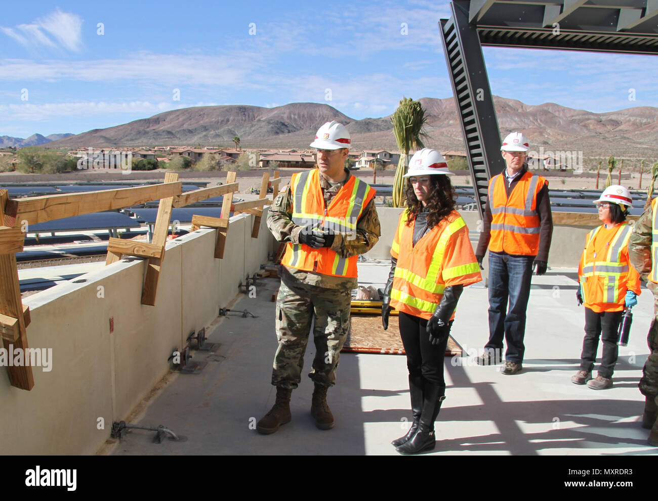 Maj. Jefferey Beeman, project program manager (L) and Cheree Peterson, director of programs, U.S. Army Corps Engineers South Pacific Division, and the senior executive project manager for the Fort Irwin Weed Army Hospital replacement construction project (r) observe on-going  construction activites from the hospital command suite patio at the new Weed Army Community Hospital construction project, Fort Irwin and The National Training Center, Ft. Irwin, California. Peterson hosted the project’s Senior Executive Review Group quarterly briefing here Dec. 1. Stock Photo