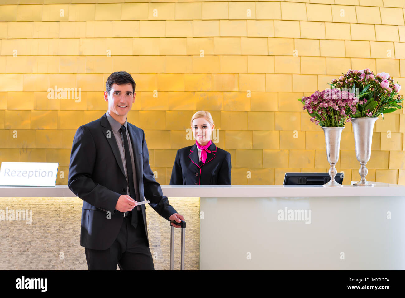 Hotel receptionist check in man giving key card Stock Photo