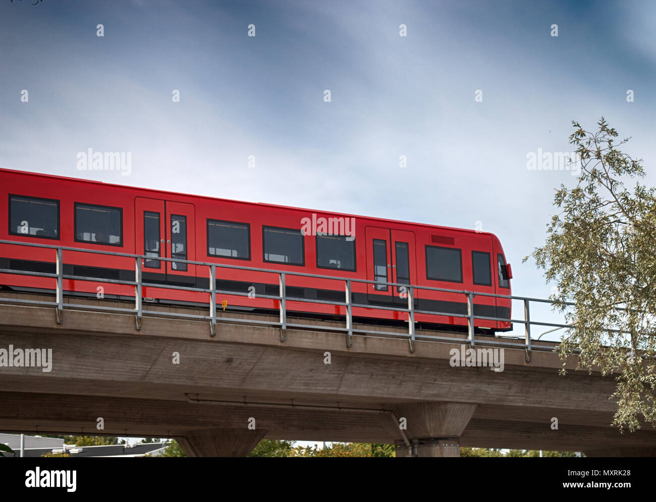 Metro train moves along rack in overhead position. Bottom view and side