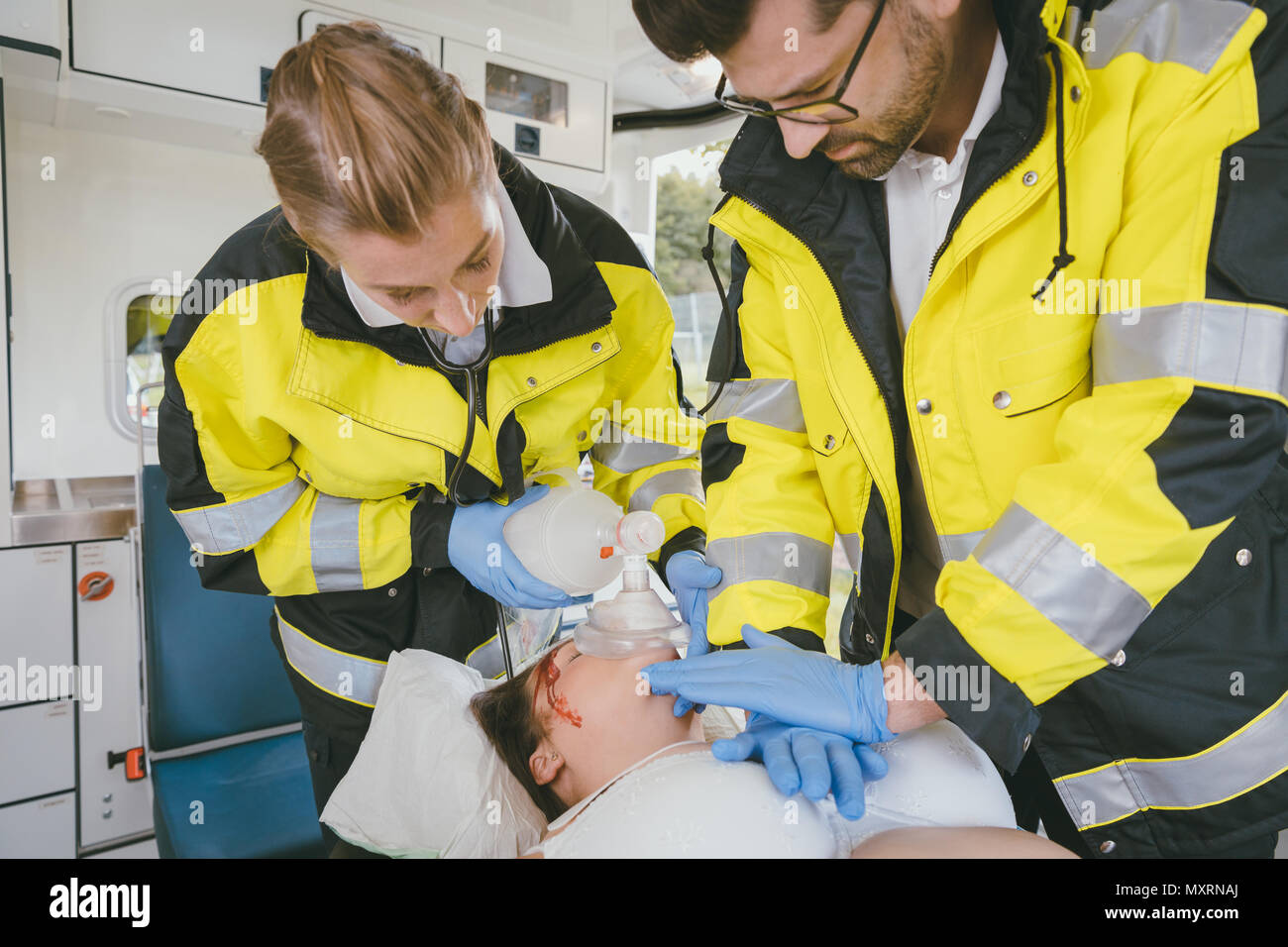 Medics putting tube in trachea of injured woman Stock Photo Alamy
