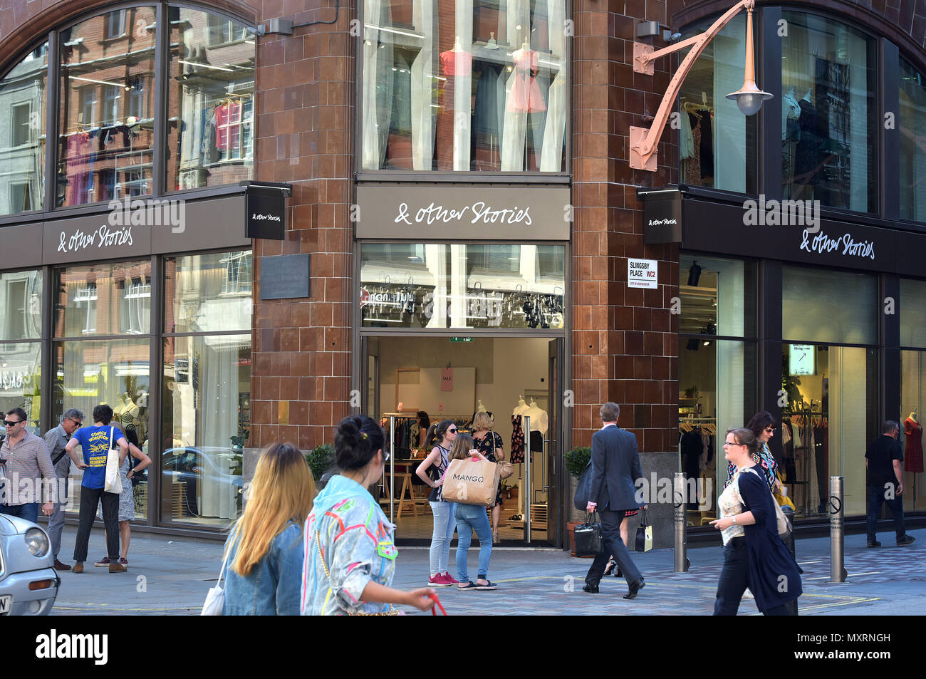 Tourists and shoppers walk past the H&M Group women’s clothing retailer & Other Stories, in Covent Garden, London. Stock Photo