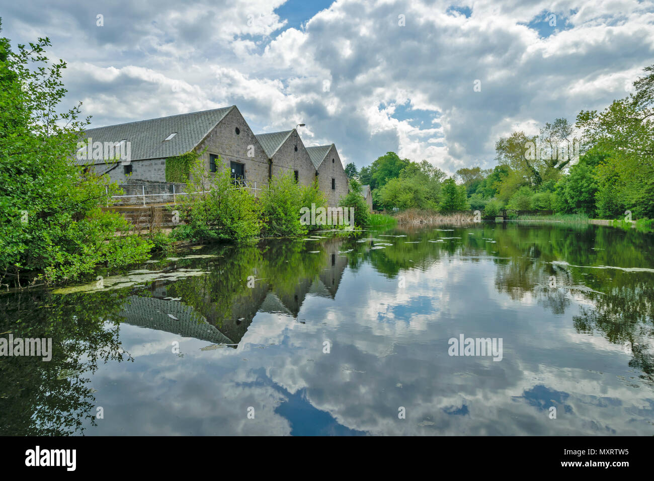 ROYAL BRACKLA WHISKY DISTILLERY CAWDOR ESTATE NAIRN SCOTLAND WAREHOUSES OVERLOOKING A SMALL LAKE