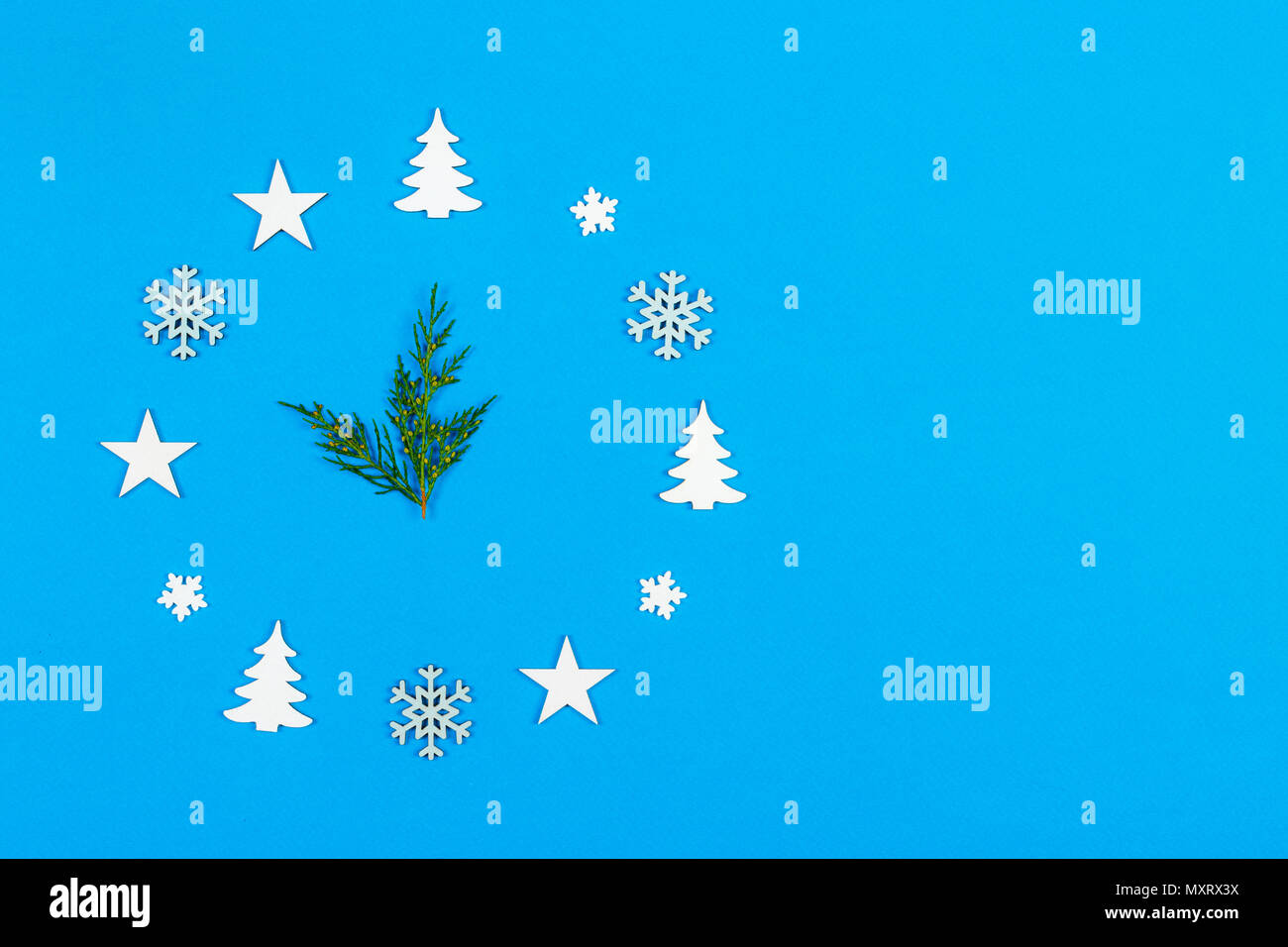 Concept clock made of christmas decoration showing five to midnight New Year on blue background with copy space. Stock Photo