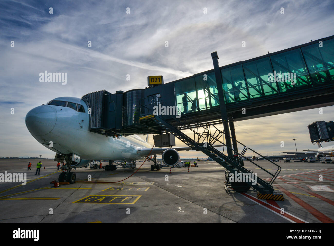 Colombier-Saugnieu (south-eastern France). 2017/10/26. Lyon Saint-Exupery Airport. Passengers disembarking from an airplane on the tarmac. Sunset Stock Photo