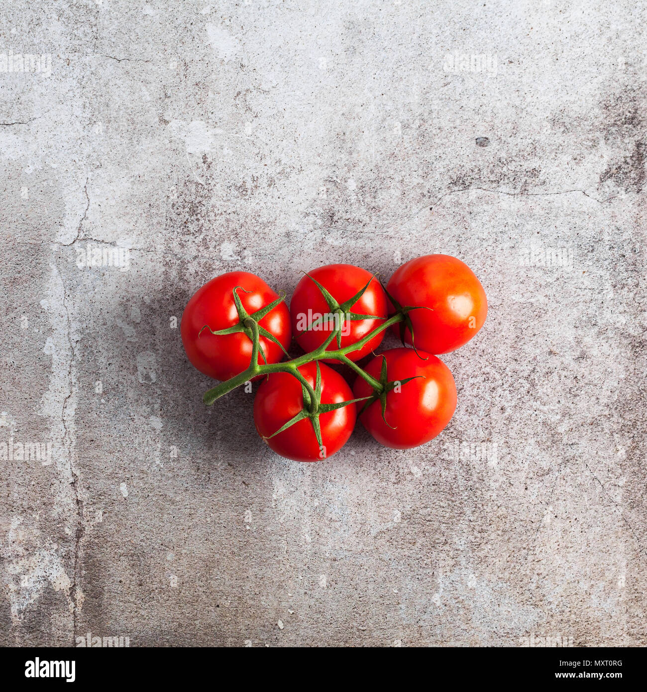 a bunch of red ripe fresh tomato on a stone surface. copy space Stock ...