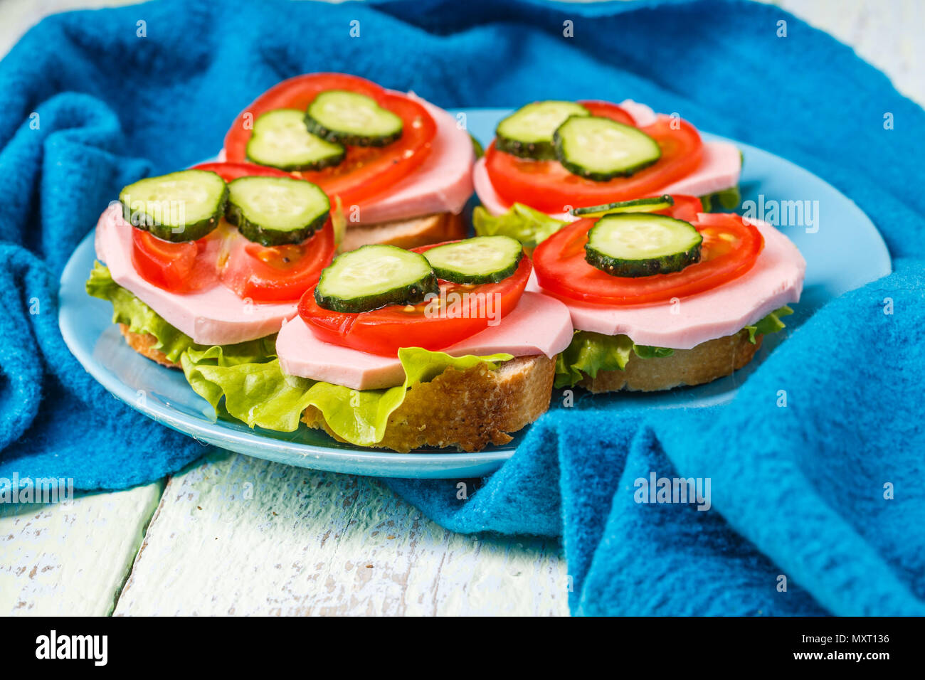 Bruschetta with salad, sausage, tomato and cucumber Stock Photo Alamy