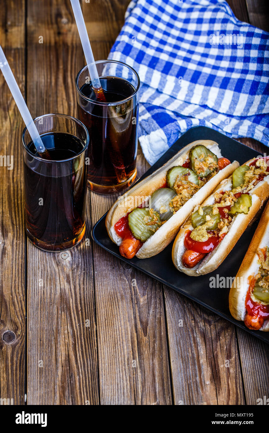 American hot dog with pickles,onions, ketchup, mustard and two soda Stock Photo Alamy