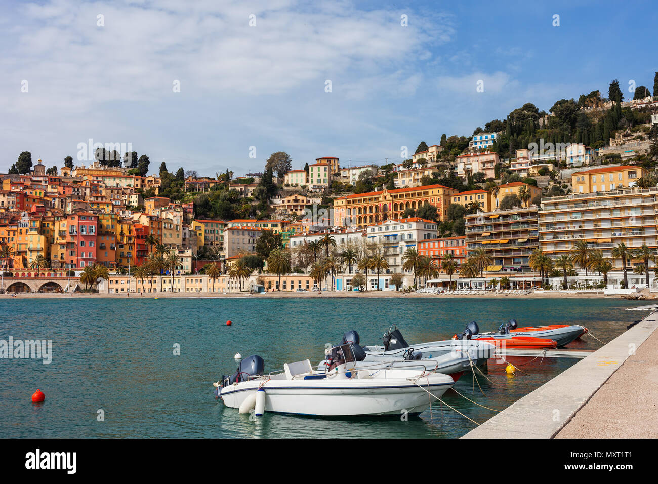 France, Cote d'Azur, Menton skyline and boats at bay waterfront, resort town on French Riviera at Mediterranean Sea Stock Photo