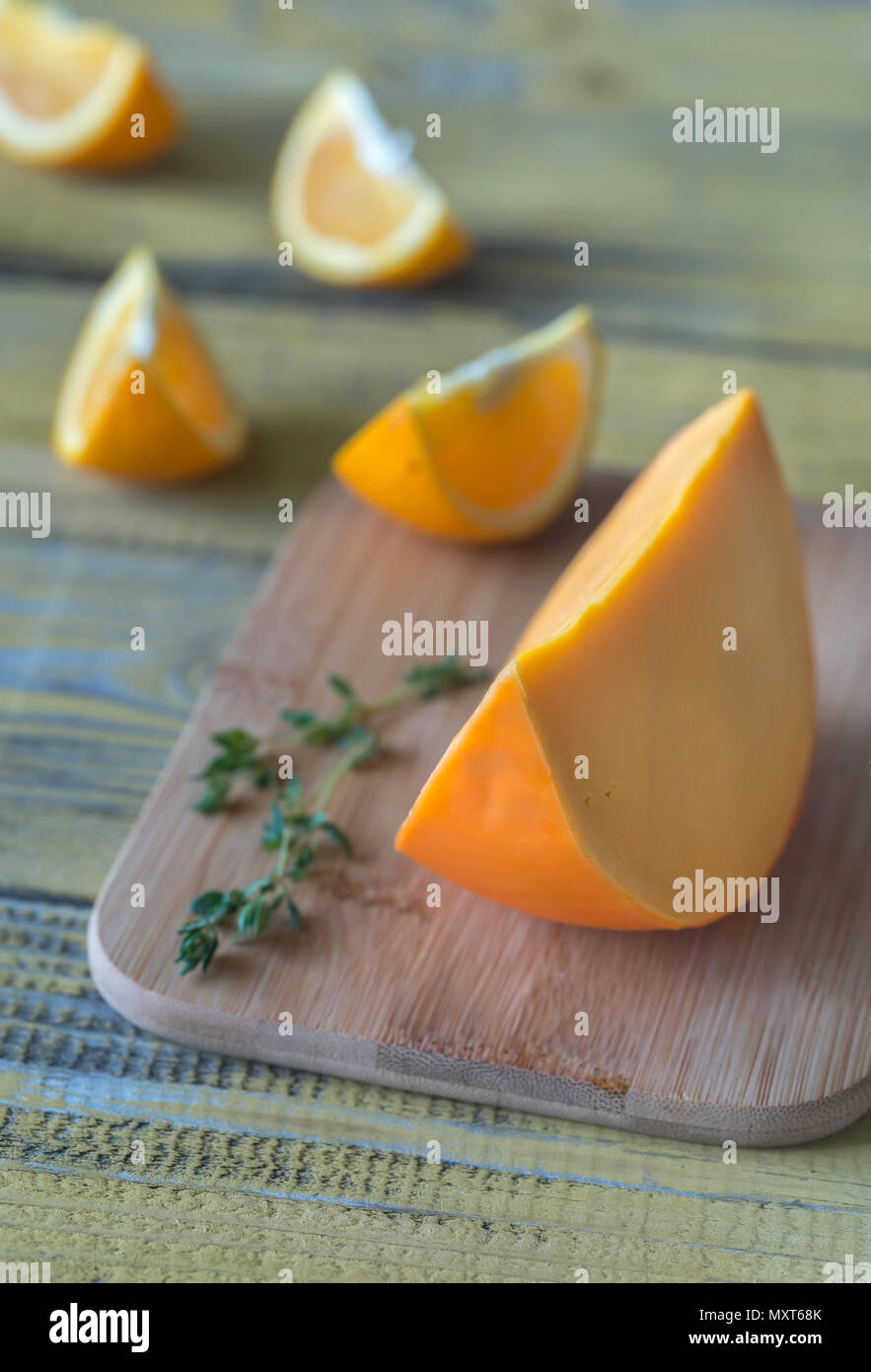 Mimolette cheese on the wooden board Stock Photo