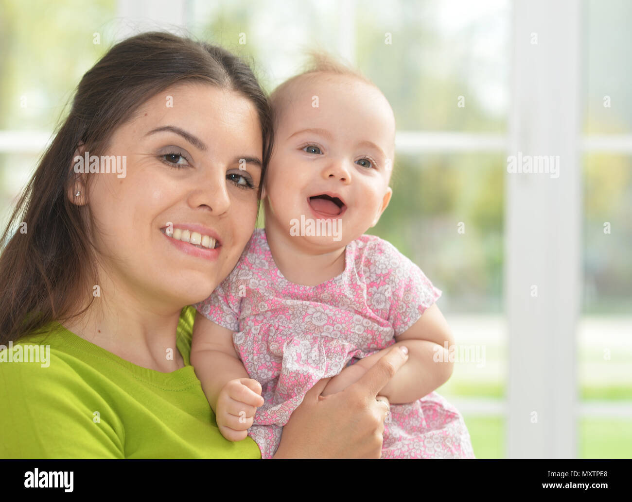 young woman with  baby girl at home Stock Photo