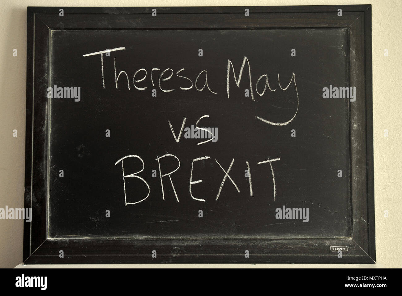 Theresa May vs BREXIT written in white chalk on a blackboard. Stock Photo