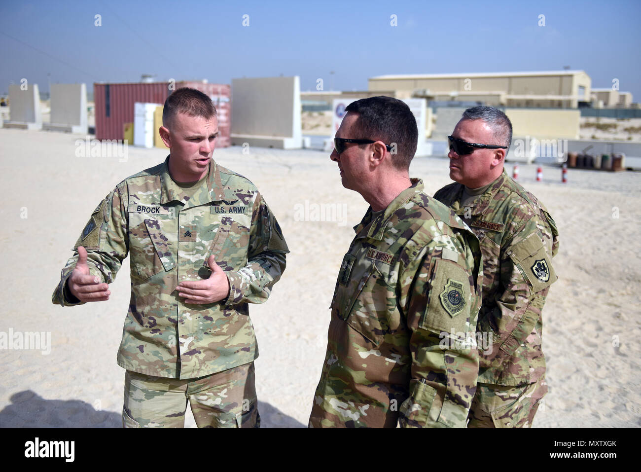 Air Force Gen. Joseph Lengyel, chief, National Guard Bureau, center, and Air Force Chief Master Sgt. Mitchell Brush, senior enlisted advisor to the chief of the National Guard Bureau, right, receive a briefing during a Thanksgiving visit with troops serving in Kuwait, Nov. 25, 2016. (U.S. Army National Guard photo by Sgt. 1st Class Jim Greenhill) Stock Photo