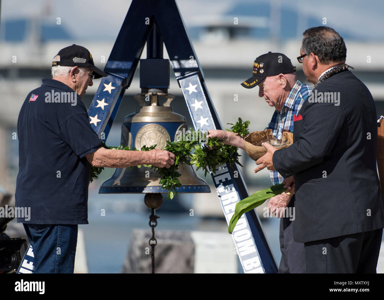 161206-N-LY160-147 PEARL HARBOR (Dec. 6, 2016) Kahu Kelekona Bishaw, right, and World War II veterans perform a blessing during an America's Freedom Bell ringing ceremony at the USS Bowfin Submarine Museum and Park. Dec. 7, 2016, marks the 75th anniversary of the attacks on Pearl Harbor and Oahu. The U.S. military and the State of Hawaii are hosting a series of remembrance events throughout the week to honor the courage and sacrifices of those who served Dec. 7, 1941, and throughout the Pacific theater. As a Pacific nation, the U.S. is committed to continue its responsibility of protecting the Stock Photo