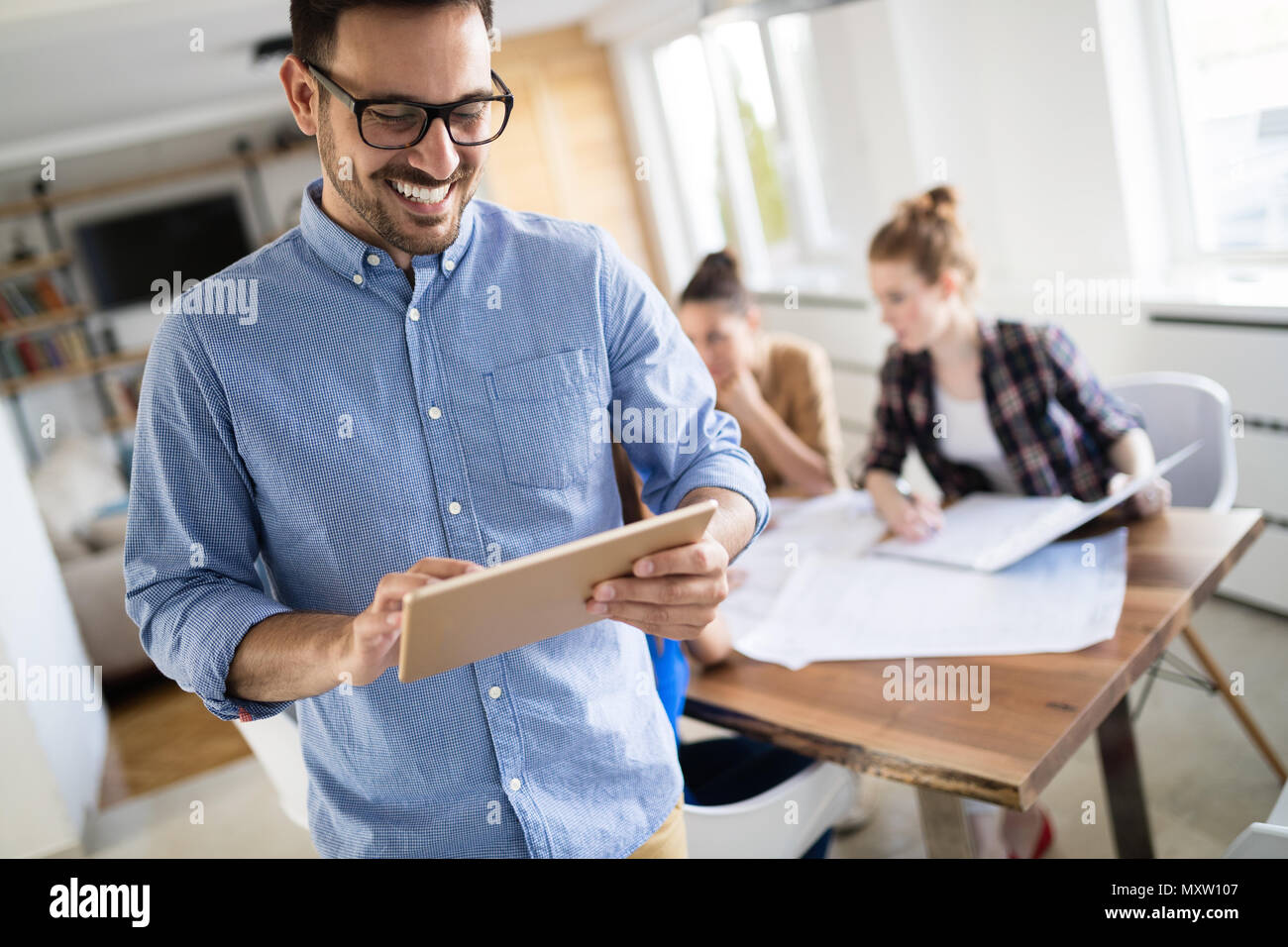 Business people and architects collaborating on project Stock Photo