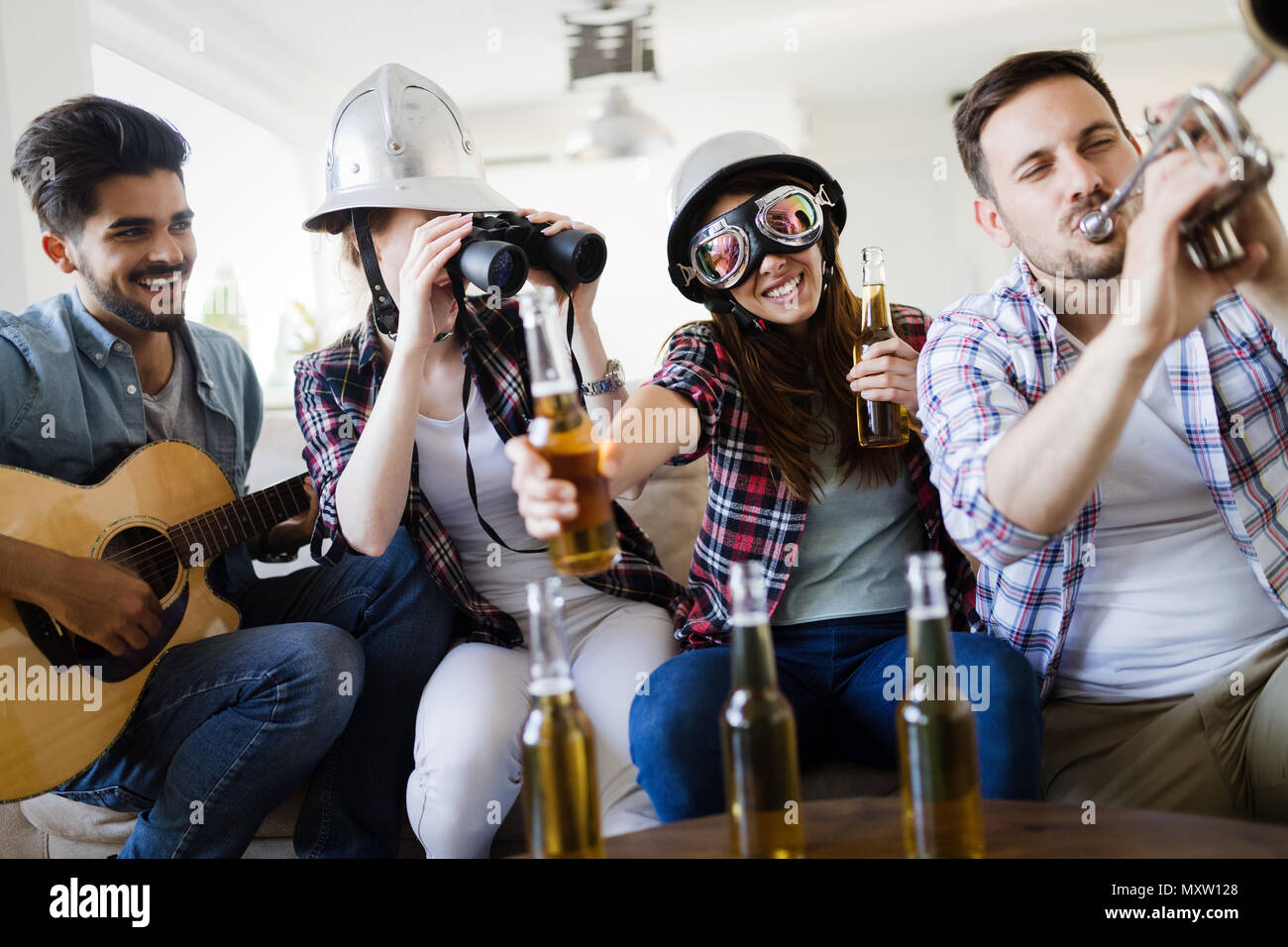 Group of happy young friends having fun and drinking beer Stock Photo