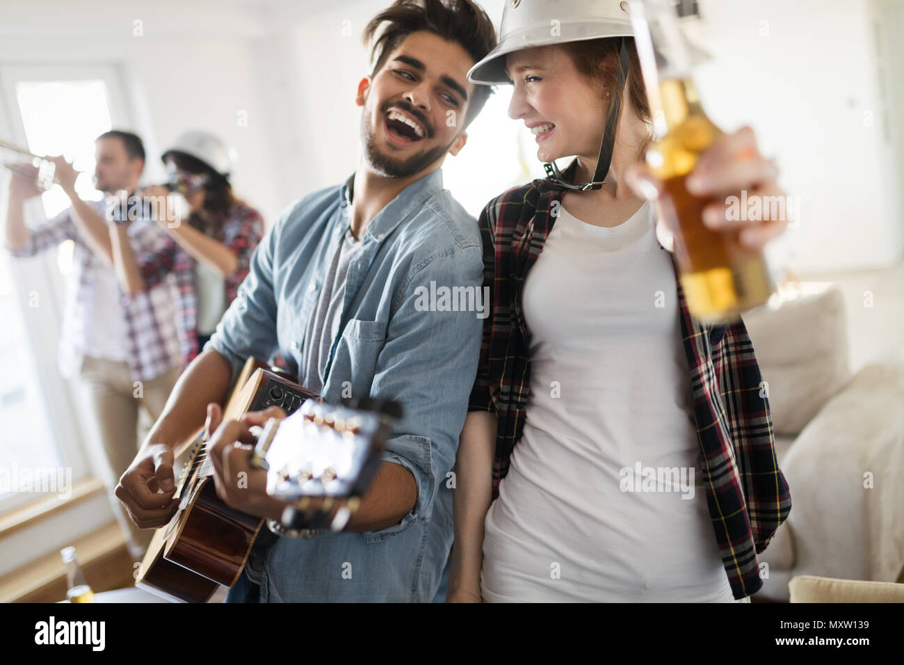 Group of happy young friends having fun and drinking beer Stock Photo