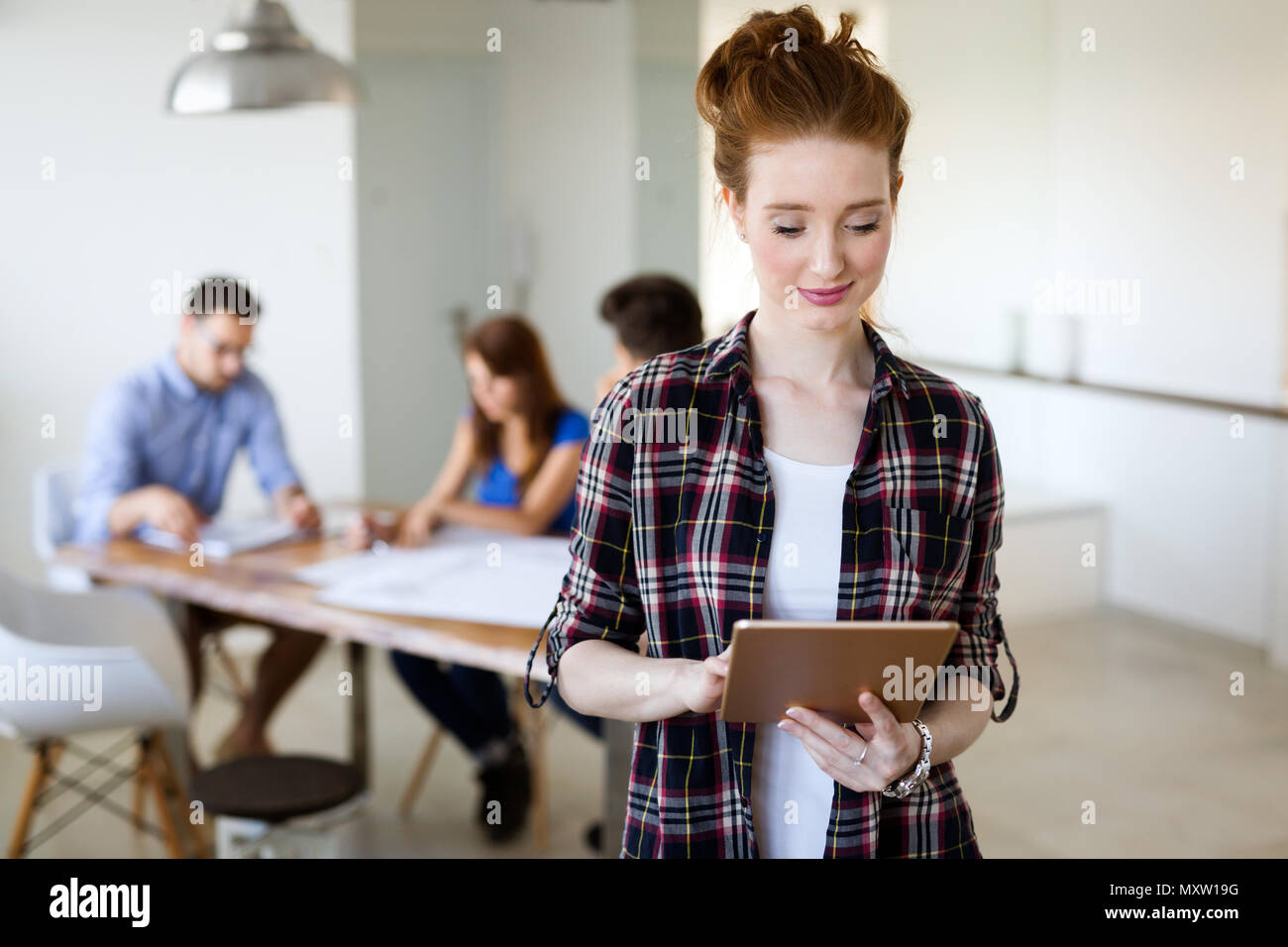 Coworking process, designers team working in modern office Stock Photo