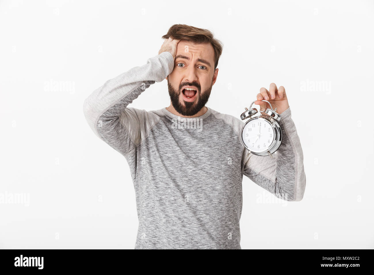 Photo of screaming scared young man isolated over white wall background