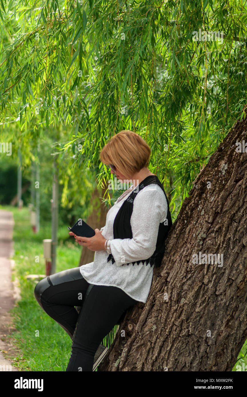 Typing mature woman leaning hi-res stock photography and images - Alamy