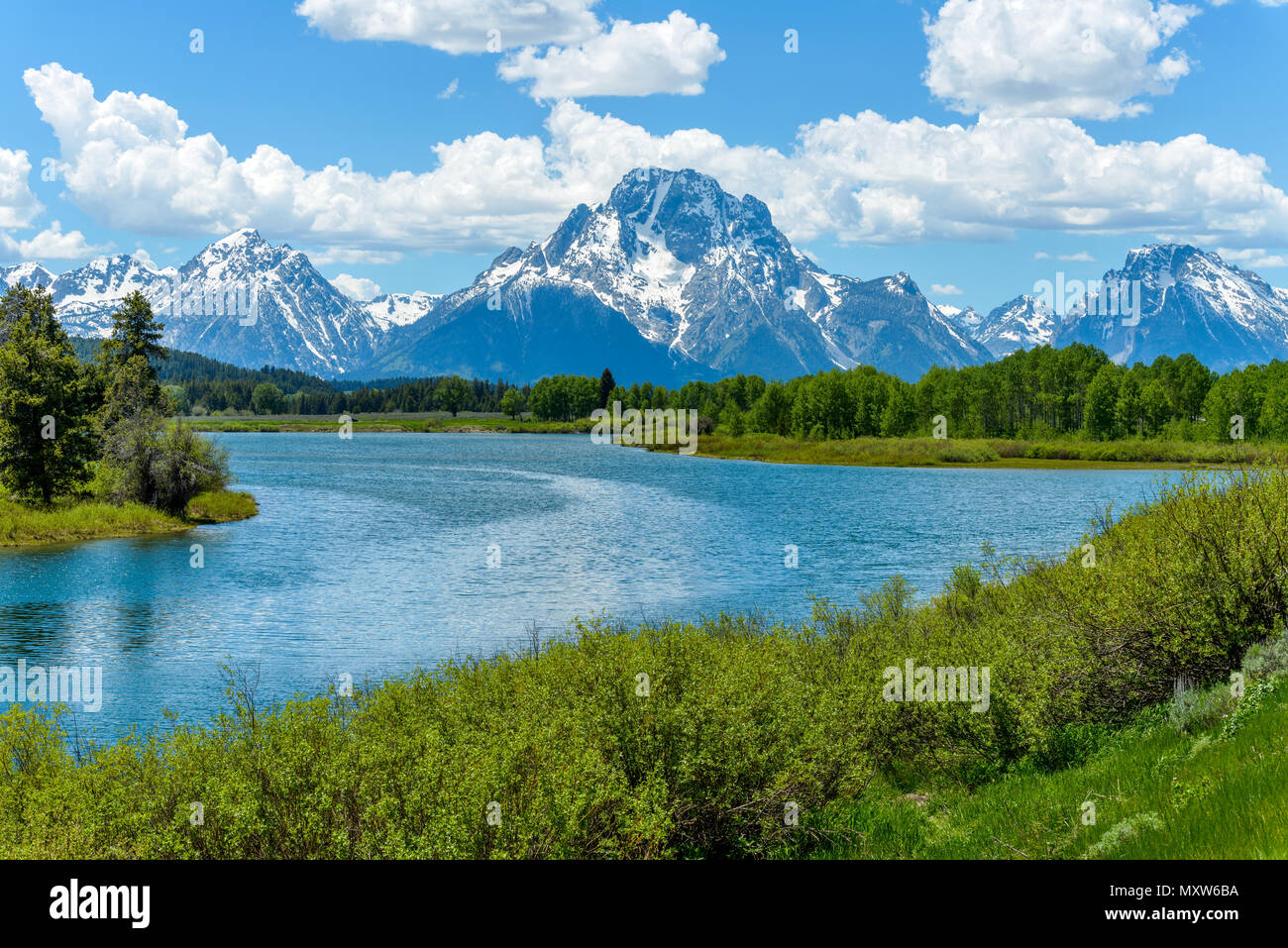 Mt. Moran at Oxbow Bend of Snake River - Spring clouds passing over snow covered Mt Moran at Oxbow Bend of Snake River in Grand Teton National Park. Stock Photo