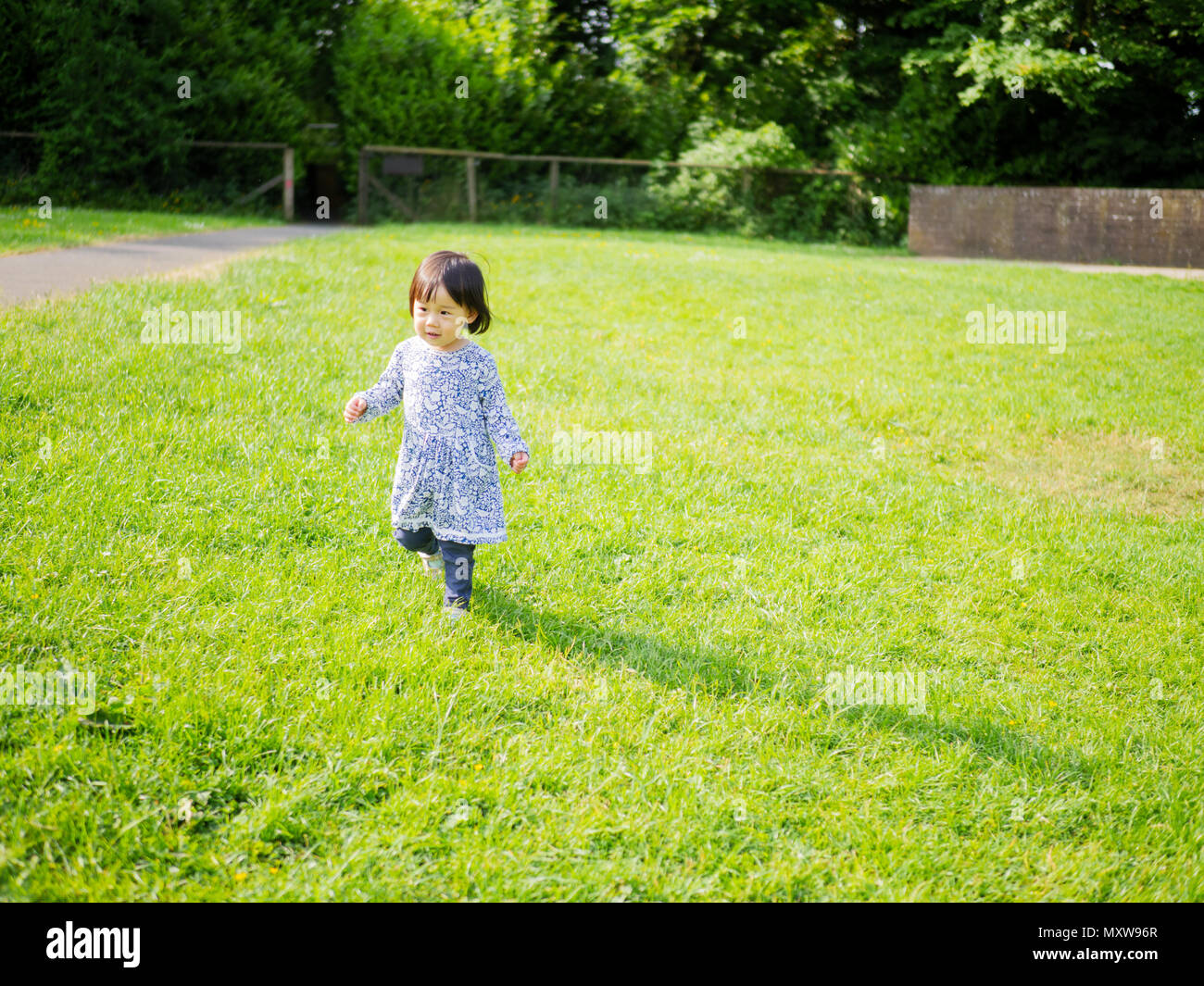 baby girl play at spring forest park Stock Photo - Alamy