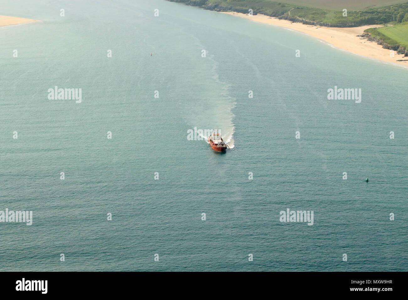 Small boat coming in from sea, in estuary, Cornwall. Stock Photo
