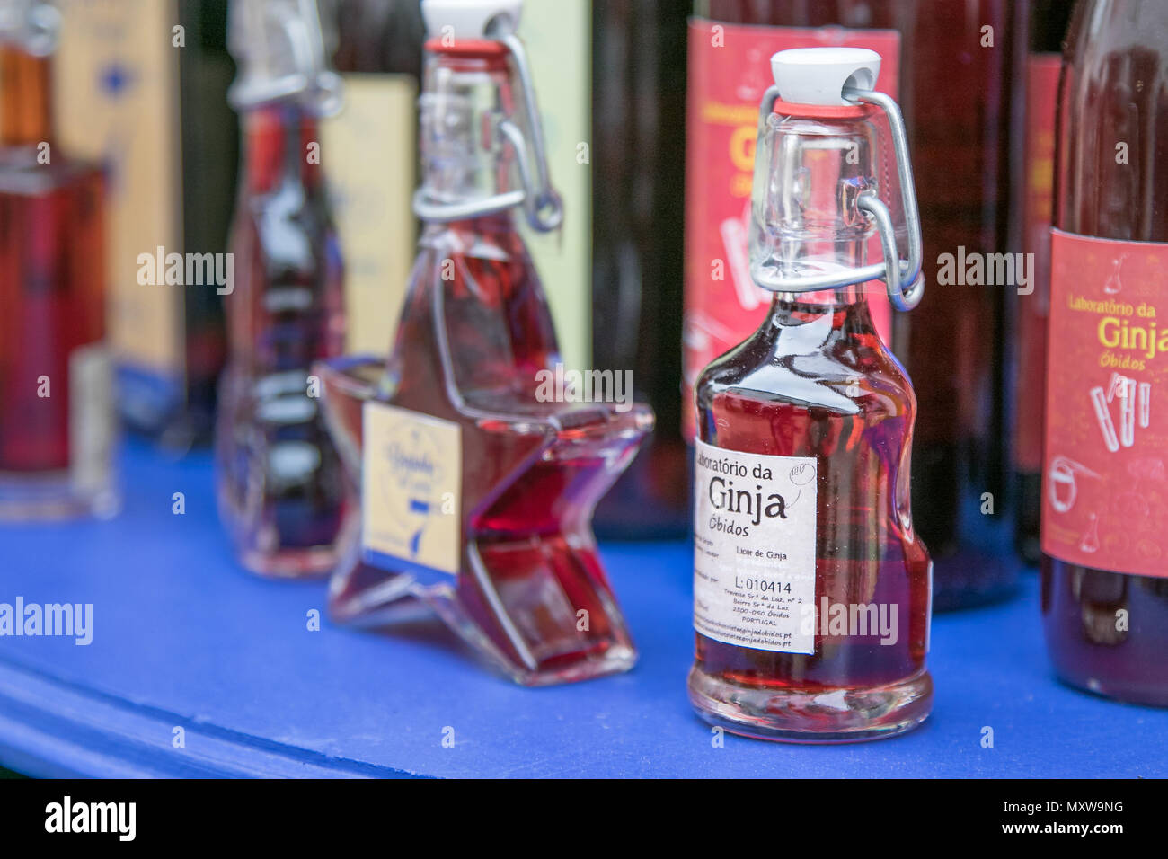 Ginja - famous Portuguese cherry liqueur - for sale on the streets of Obidos, Portugal. Stock Photo