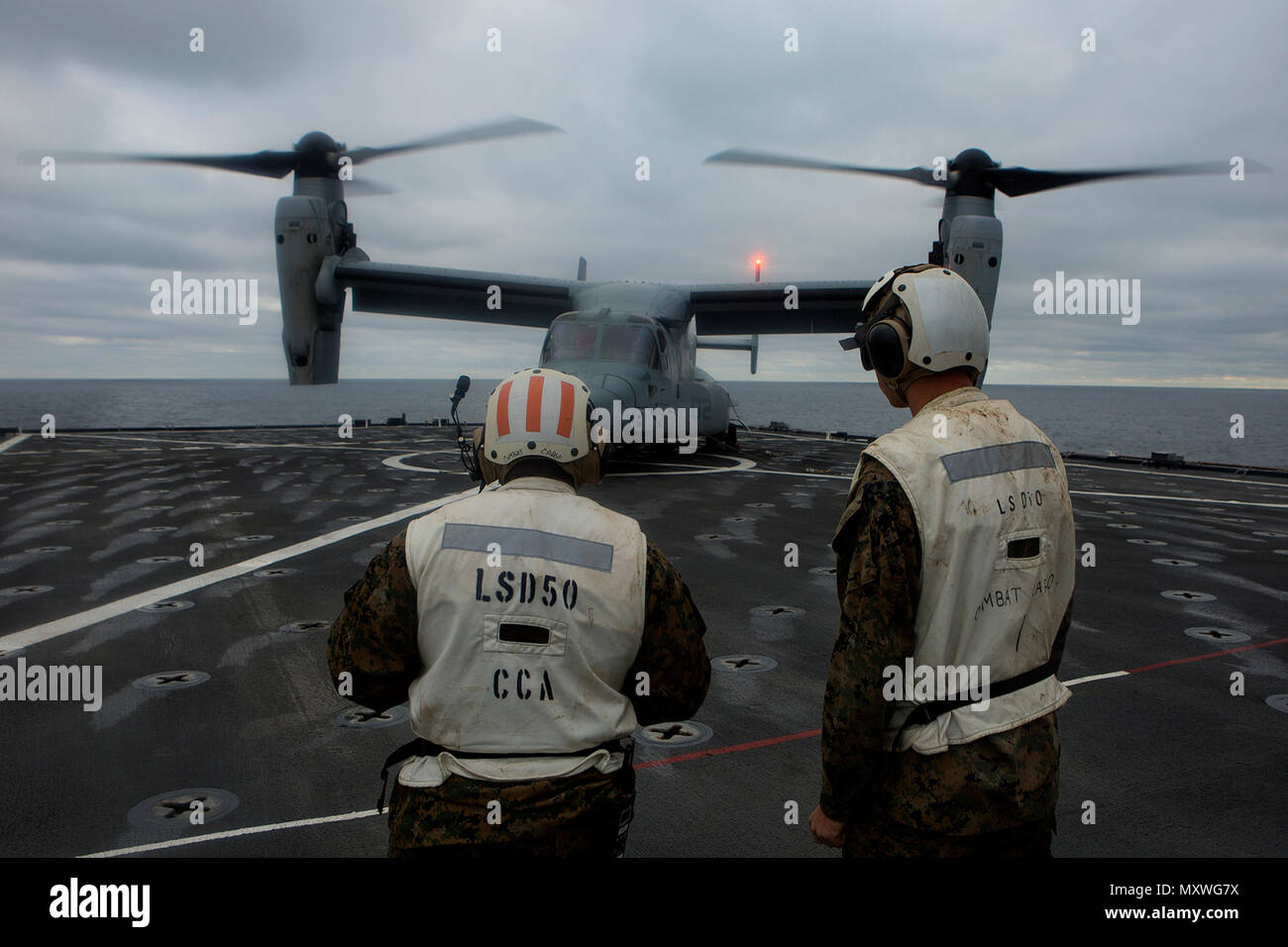Combat cargo Marines stand by after an MV-22B Osprey with Marine Medium ...