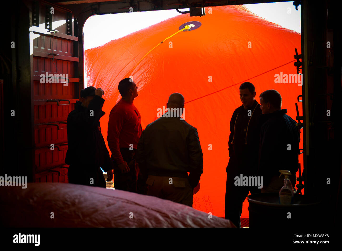 ATLANTIC OCEAN (Dec. 10, 2016) – Sailors prepare to push a “killer tomato” over the side of amphibious assault ship USS Iwo Jima (LHD 7) for a life fire training exercise. Iwo Jima is underway pursuing mobility-engineering (MOB-E) and mobility-seaman (MOB-S) certifications as part of the ship’s pre-deployment qualification process. (U.S. Navy photo by Petty Officer 3rd Class Jess E. Toner/Released) Stock Photo
