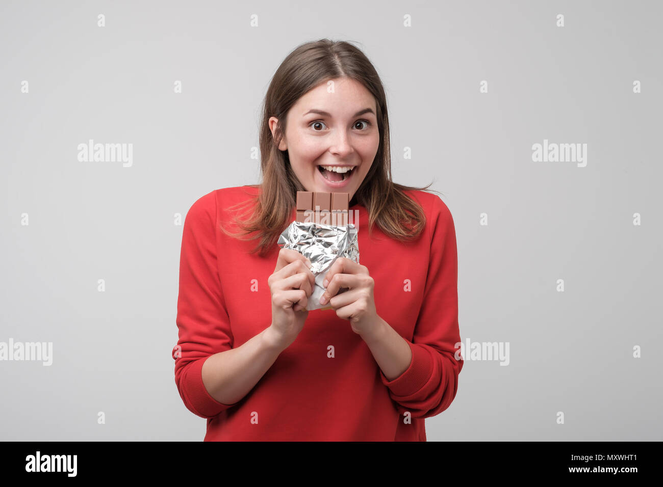 Portrait of the beautiful caucasian girl eating chocolate Stock Photo Alamy