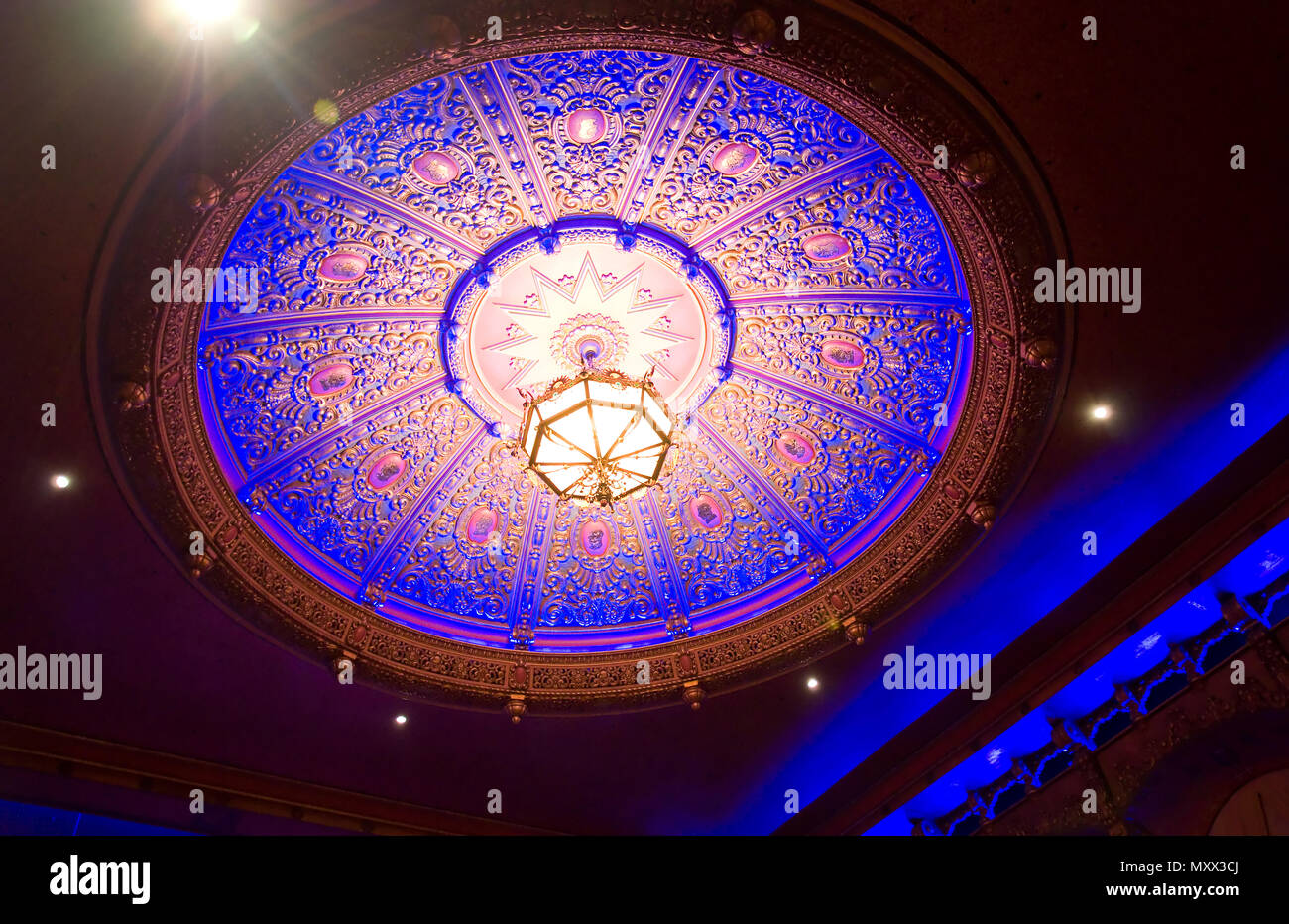 This is an ornate, vintage and very detailed ceiling light in an interior. Stock Photo