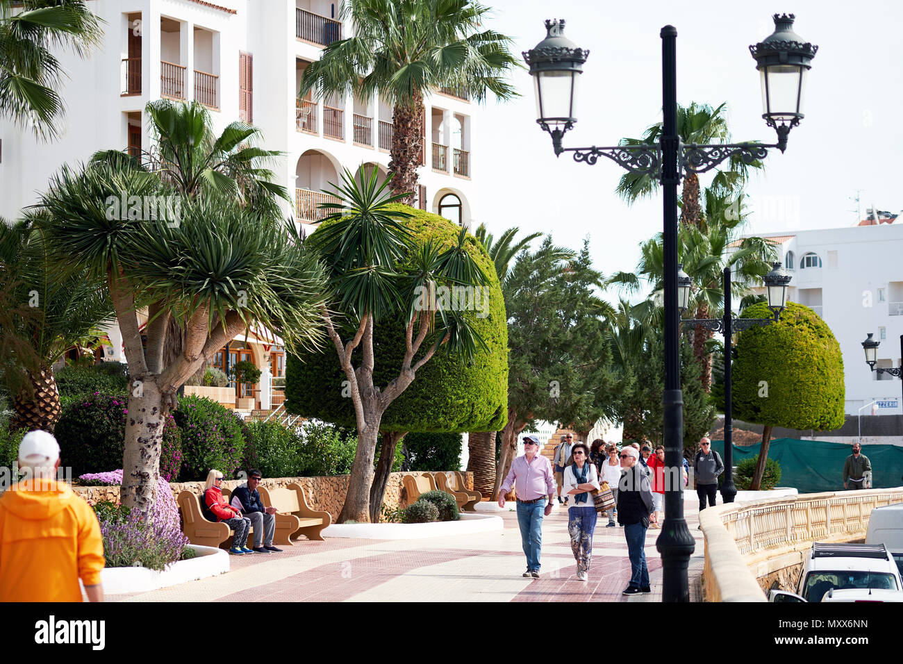 Ibiza Island, Spain - April 30, 2018: People walking by the seafront of Santa Eulalia. Santa Eulalia is a beautiful town and resort on the East coast  Stock Photo