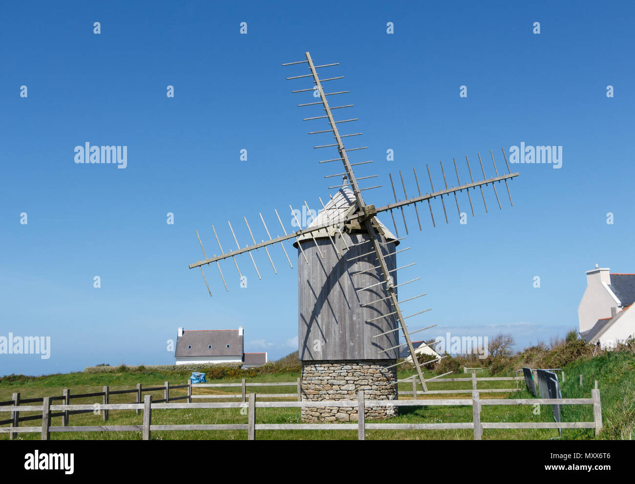 Old windmill made in wood and stones in Cleden Cap Sizun Stock Photo