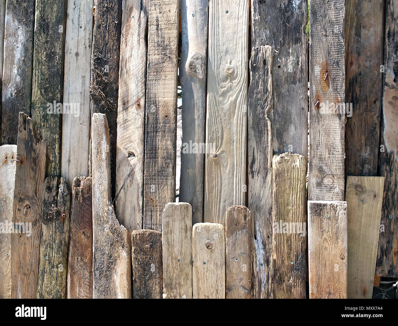 A sea wall made of planks of weathered wood Stock Photo