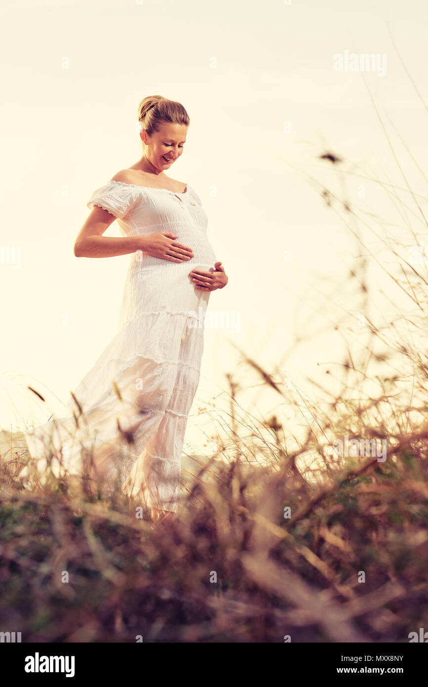 Attractive pregnant woman outdoors Stock Photo - Alamy