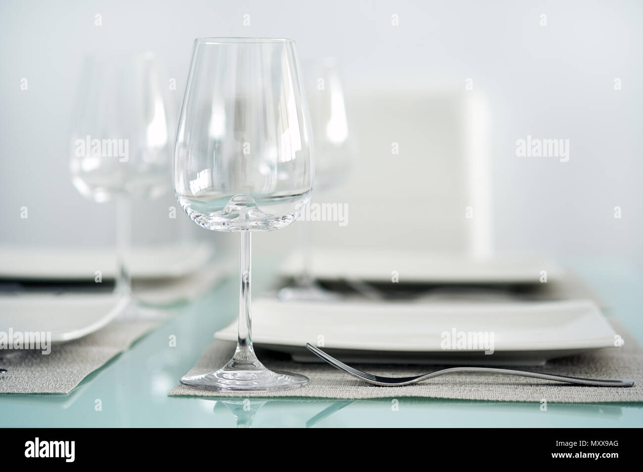Table setting with a wine glasses, cutlery and plates Stock Photo Alamy