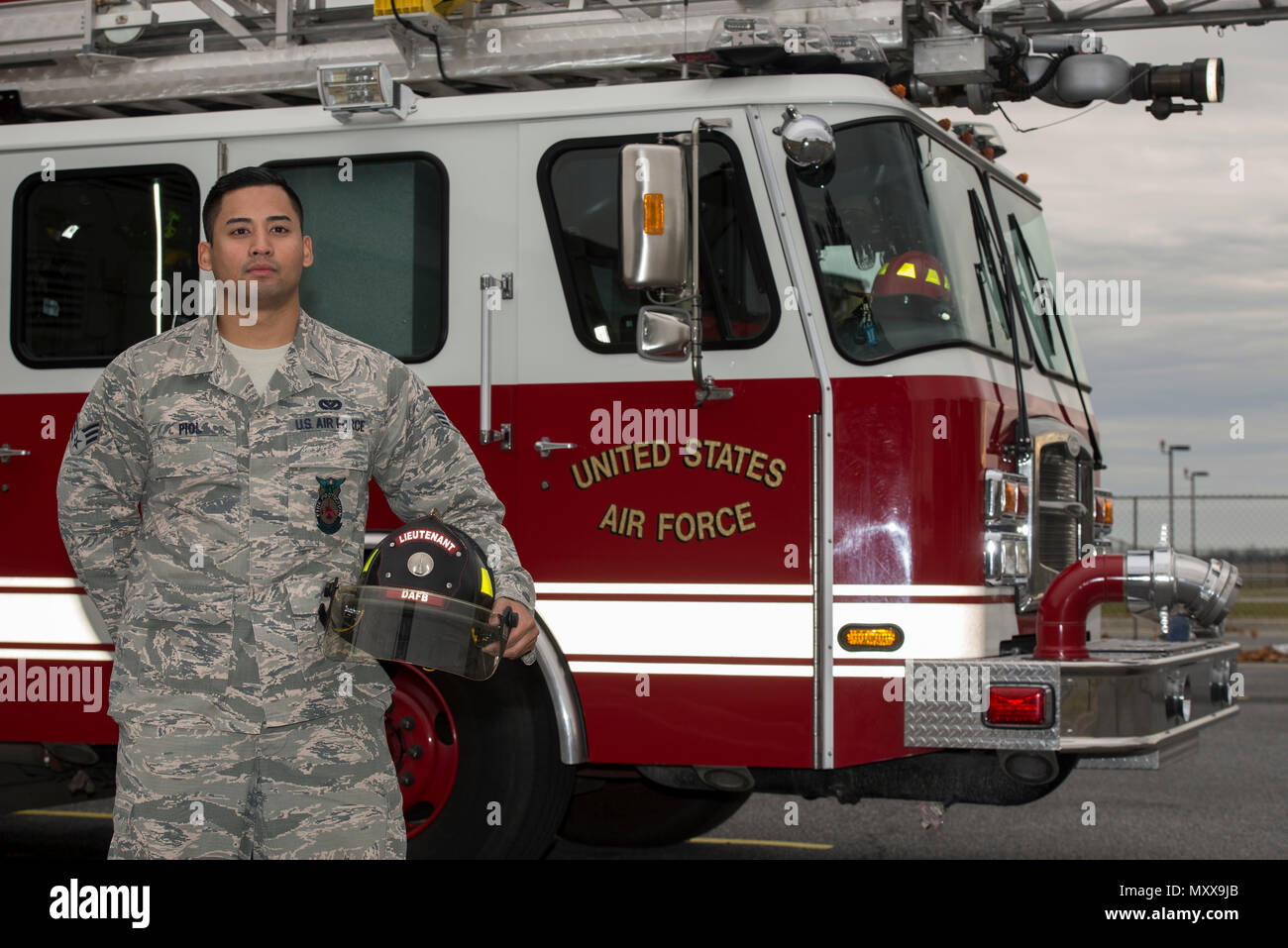Senior Airman Jason Piol, 436th Civil Engineer Squadron fire protection journeyman stands in front of a fire truck Dec. 8, 2016, by the fire department on Dover Air Force Base, Del. The fire department remains staffed 24/7, 365 days a year to ensure fire prevention for the installation at all times. (U.S. Air Force photo by Senior Airman Aaron J. Jenne) Stock Photo