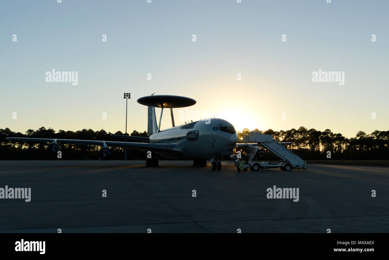 A U.S. Air Force E-3 Sentry Airborne Warning and Control System from 552nd Air Control Wing, Tinker Air Force Base, Okla., sits as the sun sets over the flightline at Tyndall Air Force Base, Fla., Dec. 6, 2016. The AWACS is at Tyndall in support of concurrent aerial exercises Checkered Flag 17-1 and Combat Archer 17-3 that runs Dec. 5-16. (U.S. Air Force photo by Airman 1st Class Isaiah J. Soliz/Released) Stock Photo