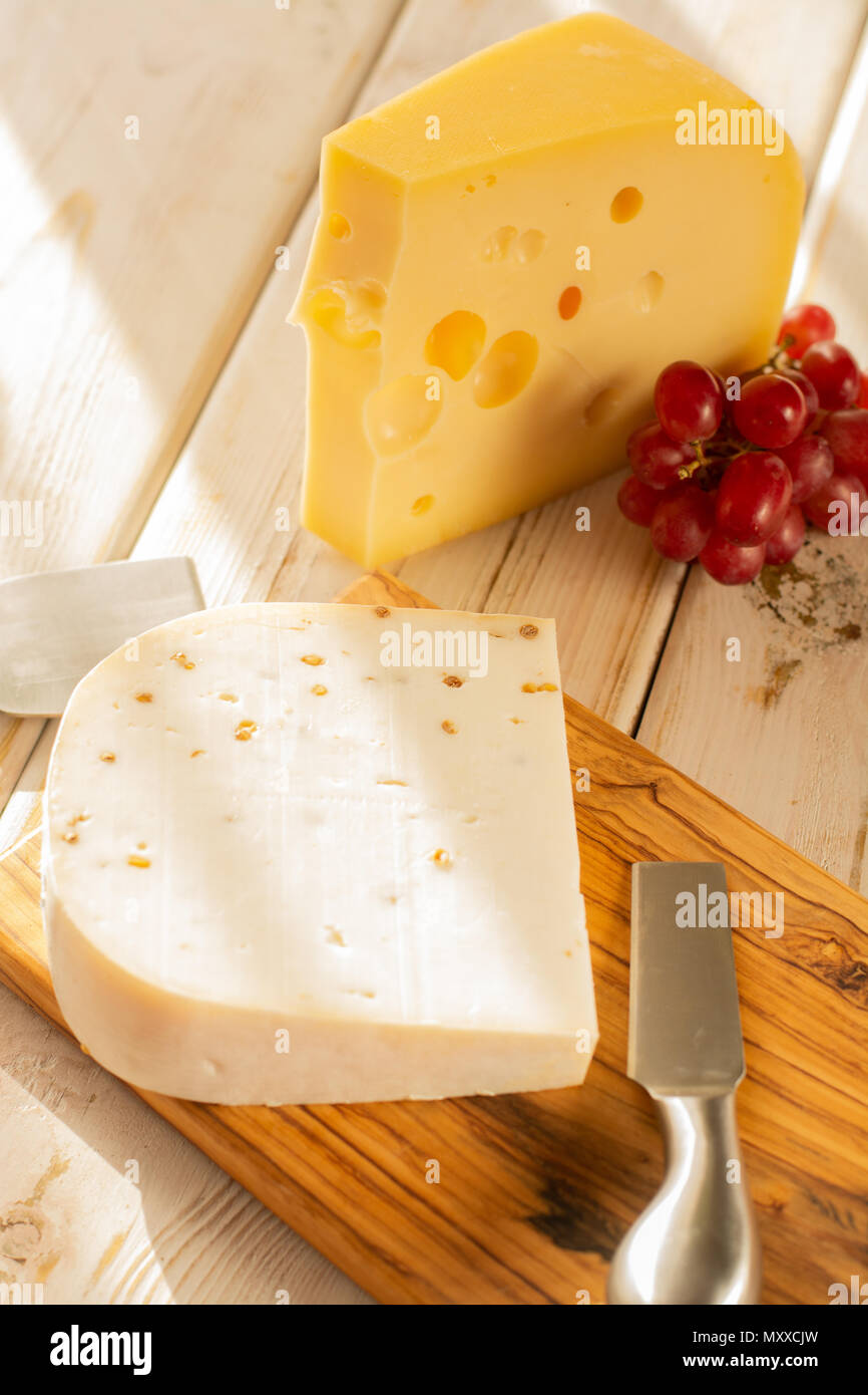 Dutch hard cheese Maasdam or Emmentaler, cheese with holes and white
